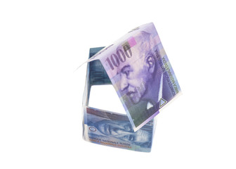 House Made of Swiss francs banknotes isolated on white.Currency