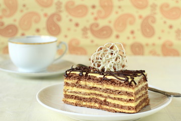 Piece of cake with cream, caramel and chocolate