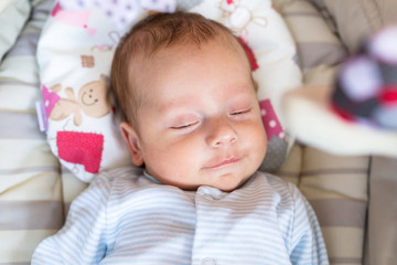 Baby boy lying down in the cradle