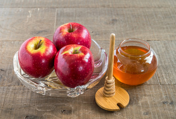 Honey and  apples  on wood deck for Rosh Hashana celebration.