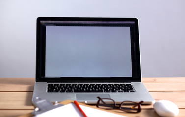 Laptop stands on a wooden table