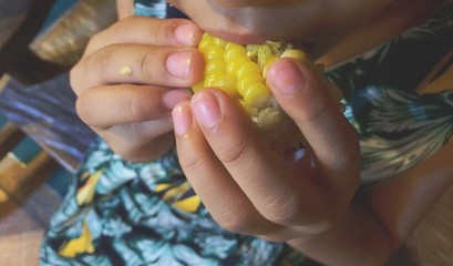 girl eating sweet corn