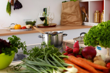 young girl is preparing vegetables in the kitchen