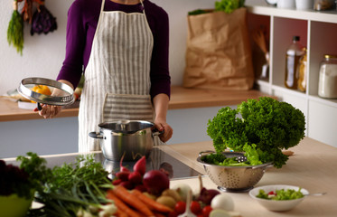 young girl is preparing vegetables in the kitchen