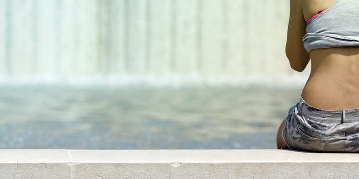 Girl relaxing in a fountain
