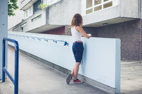 Young woman standing on housing estate
