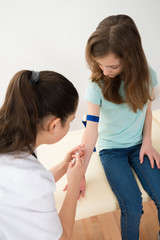 Doctor Taking Blood Sample From Patient