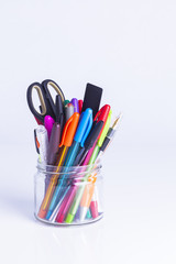 Colorful pens in glass jar