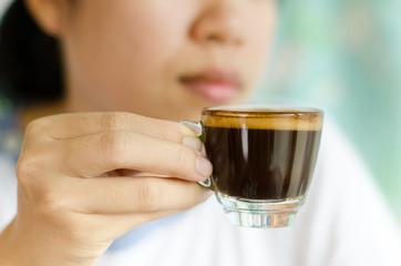 The cup of coffee (espresso) ready to drink by woman