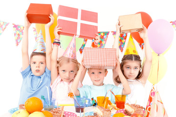 Little children posing with birthday presents 