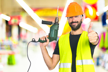 workman with drill over white background