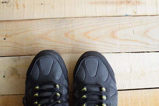 Picture of a pair of sport shoes on wood panels