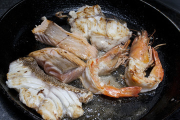 fried seafood tuna dorado fish in a frying pan