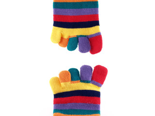 Obraz na płótnie Canvas close-up colorful striped long finger socks isolated on white background, vivid colors five toes socks winter fashion for teenage female or children