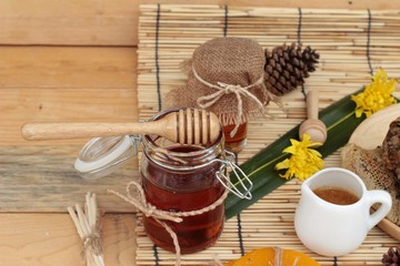Honey variety with honeycomb and honey in a jar with beeswax.