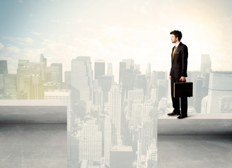 Plakat Businessman standing on the edge of rooftop