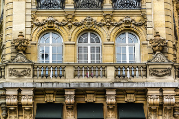 Fototapeta na wymiar French house with traditional balconies and windows. Paris.