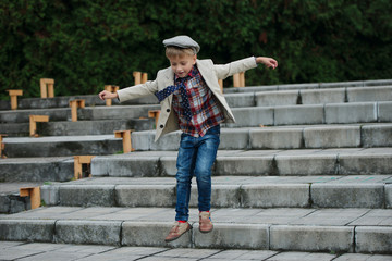 little boy jumping on the stairs