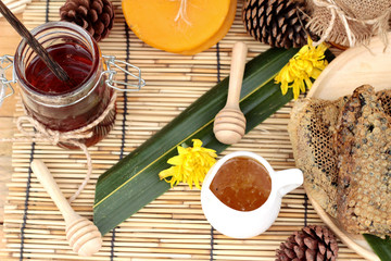 Honey variety with honeycomb and honey in a jar with beeswax.