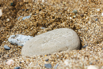 Figure game of TIC-TAC-toe painted on the pebbles