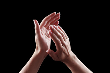 beautiful female hands isolated on black background applause