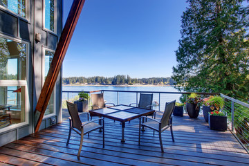 Large covered porch of luxury home with lake view.