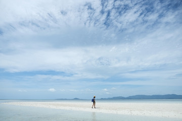 Fototapeta na wymiar Beach travel - woman walking on sandy beach at Koh Phangan, Southern Thailand