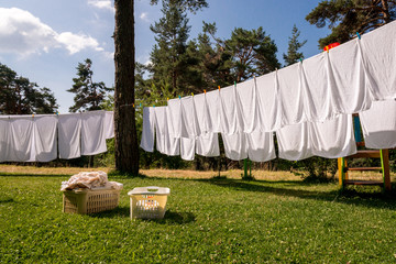 fresh clean white towels drying on washing line in outdoor