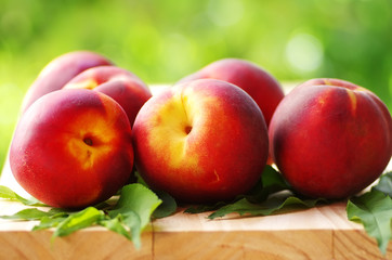peaches and leaves on table