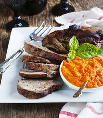 Baked leg of Lamb with red pepper sauce