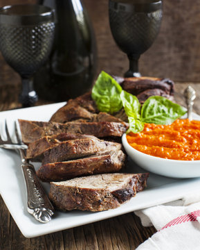 Baked leg of Lamb with red pepper sauce