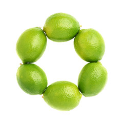 Multiple ripe limes aligned in a circle round frame, composition