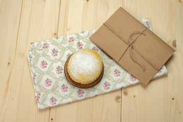 Homemade milk biscuits with powdered sugar on a saucer on napkin