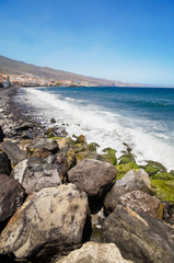 Fototapeta na wymiar Black sandy beach in famous Candelaria town in Tenerife, Canary Island, Spain. .