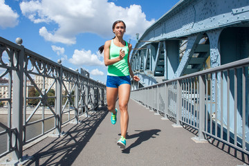 caucasian woman running on the metal bridge