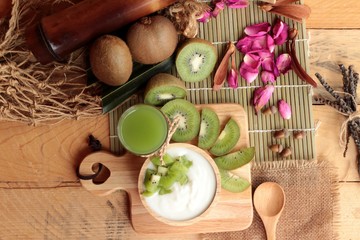 Yogurt white with green kiwi fruit and kiwi juice.