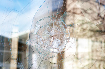 bullet holes in the window of the shop