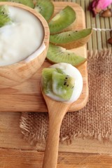 Yogurt white with green kiwi fruit and kiwi juice.