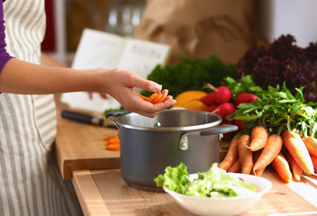 Young woman cutting vegetables in the kitchen
