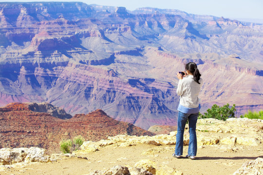 Teen girl taking pictures at the Grand Canyon