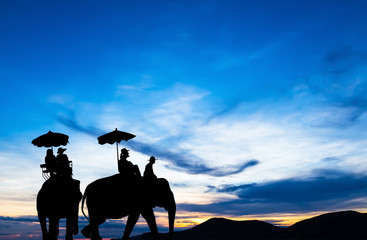 Fototapeta na wymiar silhouette elephant with tourist at sunset