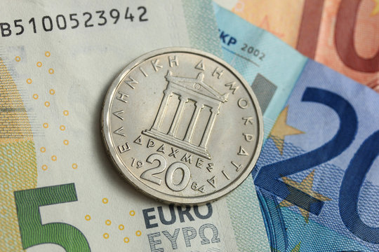 Drachma coin on euro note