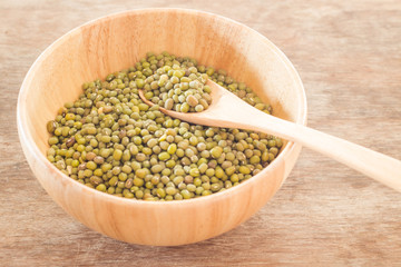 Raw green bean in wooden bowl
