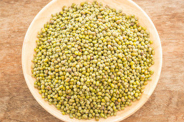 Raw green bean in wooden plate