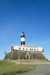 Fototapeta na wymiar Portrait of the Farol da Barra lighthouse under clear blue sky in Salvador, Bahia, Brazil 