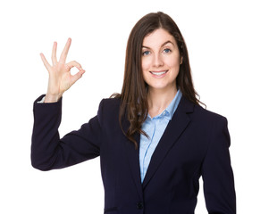 Caucasian young businesswoman with ok sign gesture