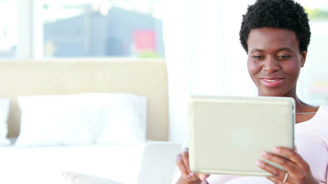 Happy couple using tablet and reading book