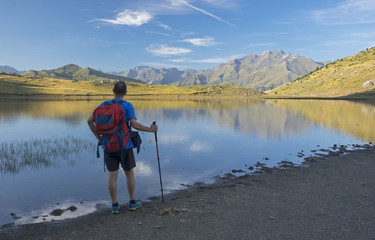 Fototapeta na wymiar Man playing sports on the mountain, lake Piedrafita, Huesca Pyrenees