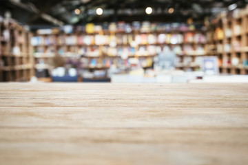 Table top Counter with Blurred Bookshelf Bookstore Background - obrazy, fototapety, plakaty