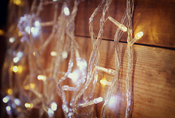 Christmas warm gold garland lights on wooden rustic background